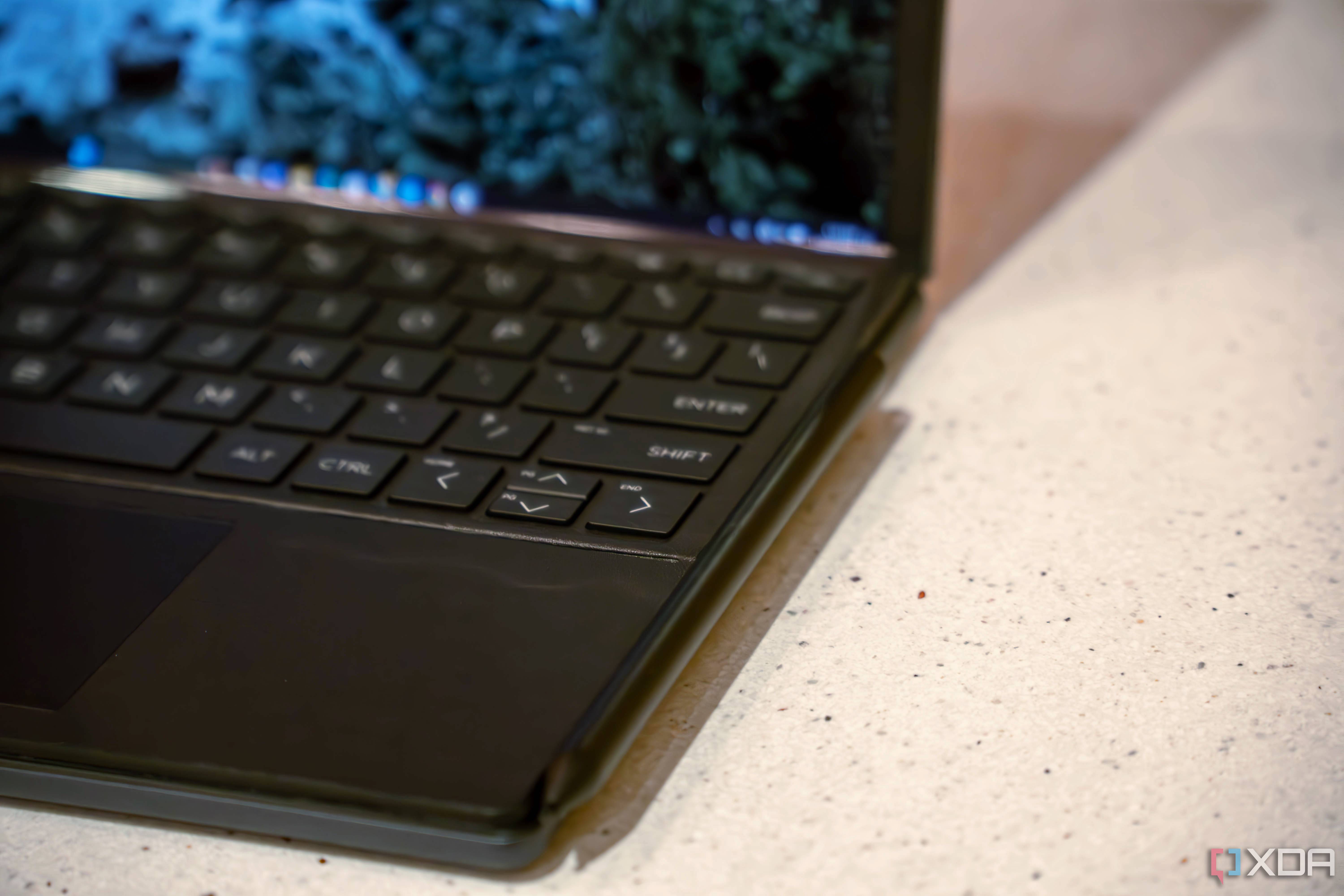 Close up of pen attached to side of keyboard