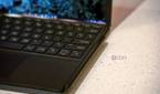 Close up of pen attached to side of keyboard
