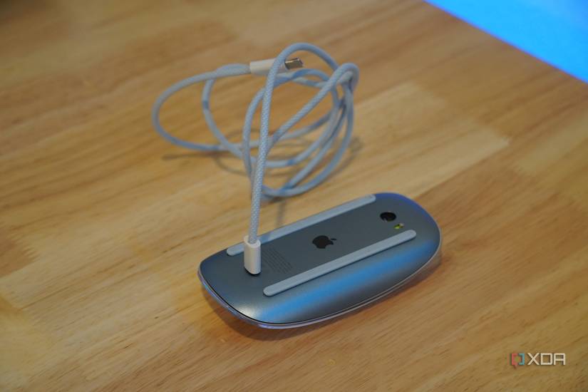 A Magic Mouse connected to a Lightning cable. 
