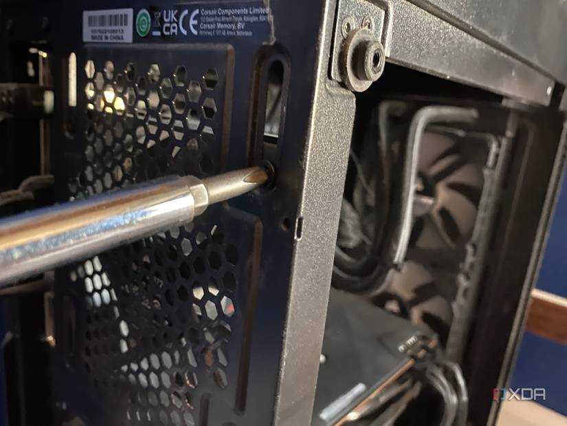 Using screwdriver to remove PC case fan
