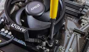 An image showing a CPU fan being screwed onto a motherboard.