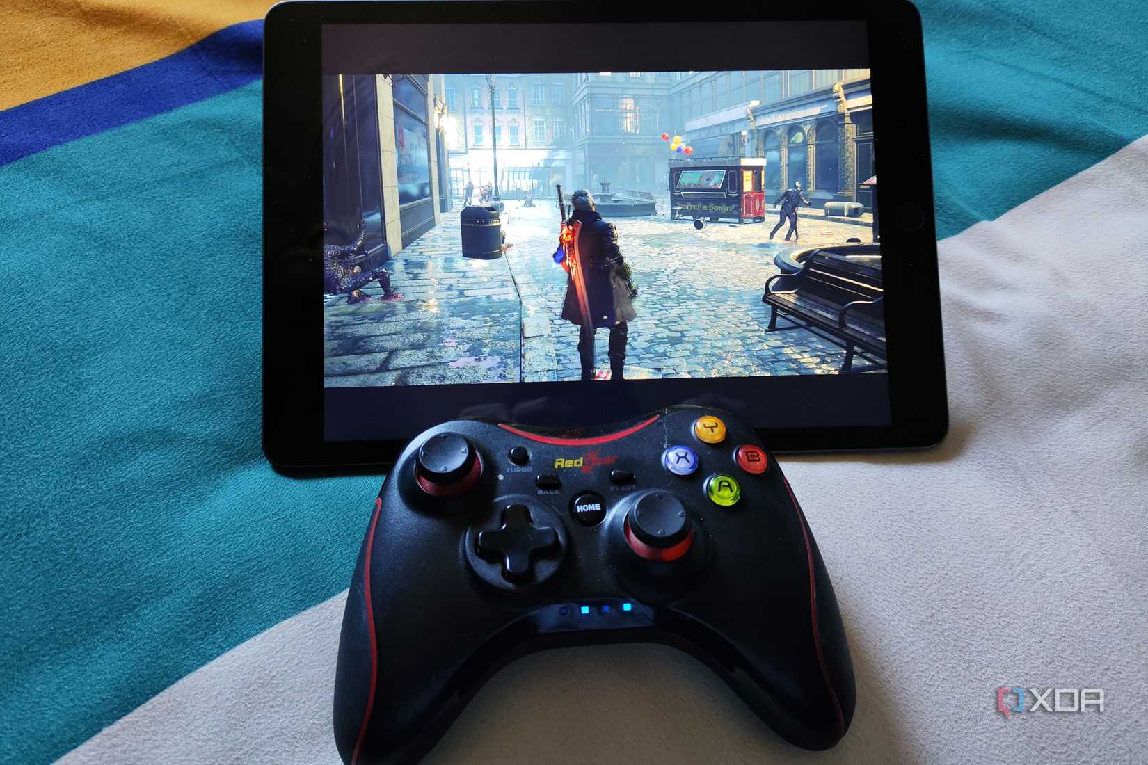 An image of an iPad running Devil May Cry 5 with a RedGear controller nearby