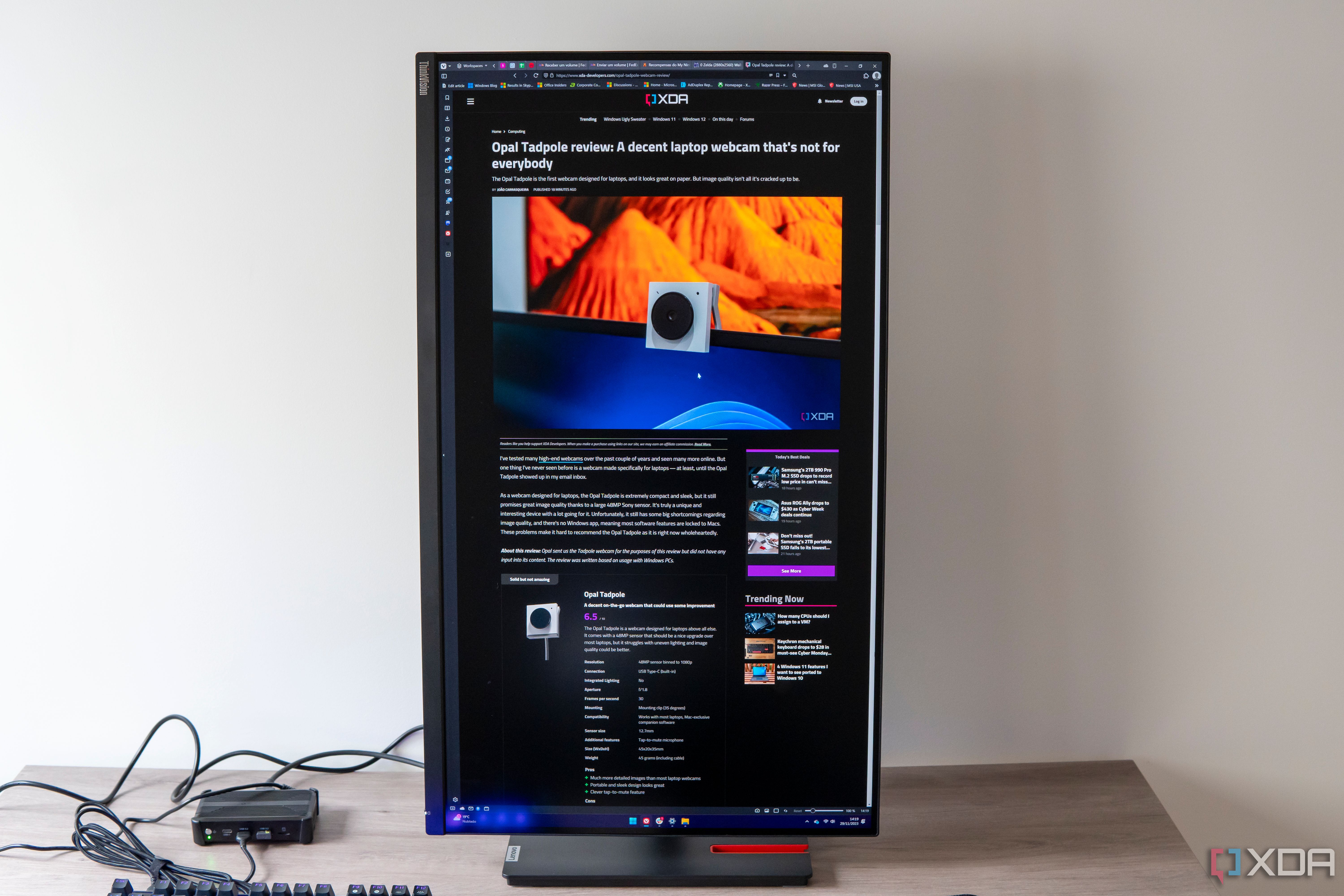 Front view of the Lenovo ThinkVision P32p-30 in portrait orientation displaying an article on XDA
