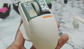 An image showing a person holding the Lofree PBT wireless mouse.