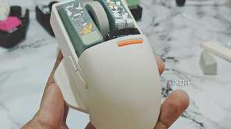 An image showing a person holding the Lofree PBT wireless mouse.