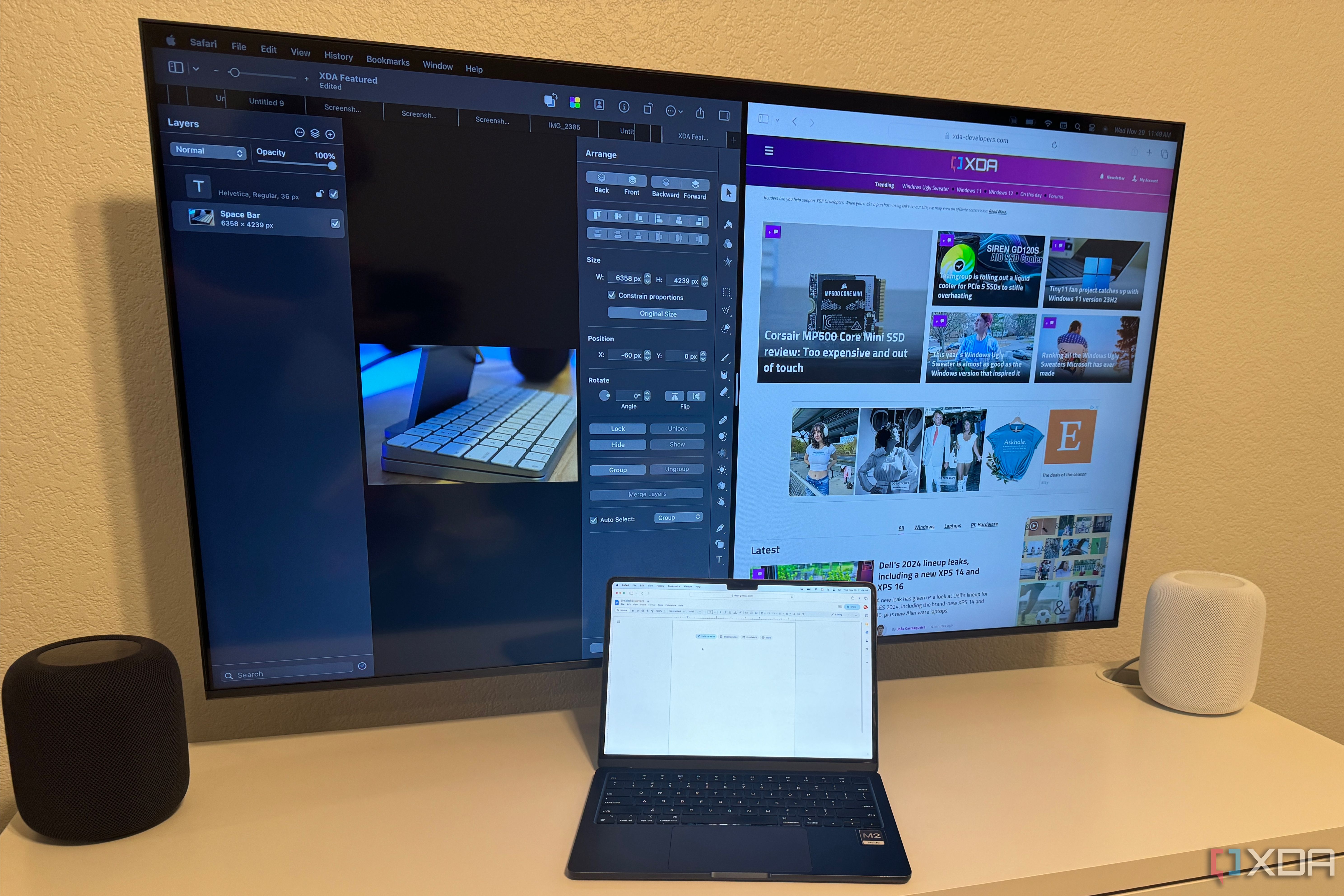 A MacBook Air on a desk connected to an Apple TV. 