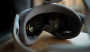 Pico 4 VR headset pancake lenses on the inside of the headset, as it rests on a stool