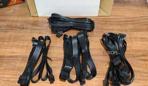 An image showing PSU cables that are neatly arranged on a wooden table.