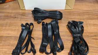 An image showing PSU cables that are neatly arranged on a wooden table.