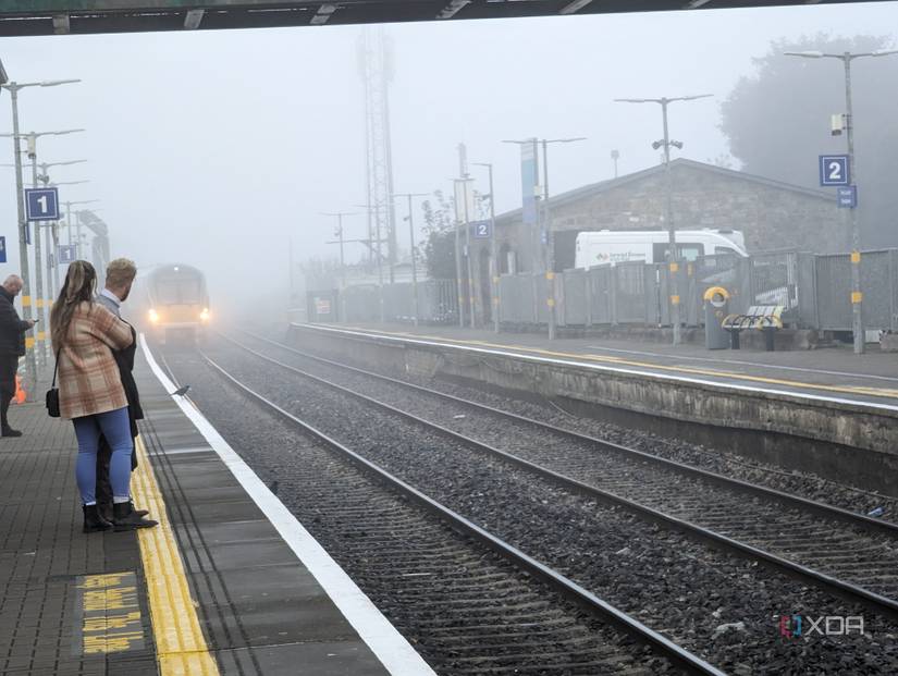 Train arriving into a train station in Ireland in the fog