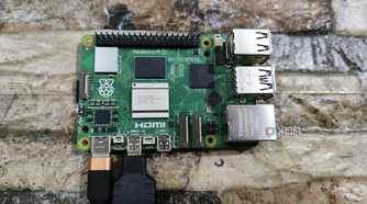 A Raspberry Pi 5 with a USB Type-C charging cable and a micro HDMI to HDMI adapter plugged in