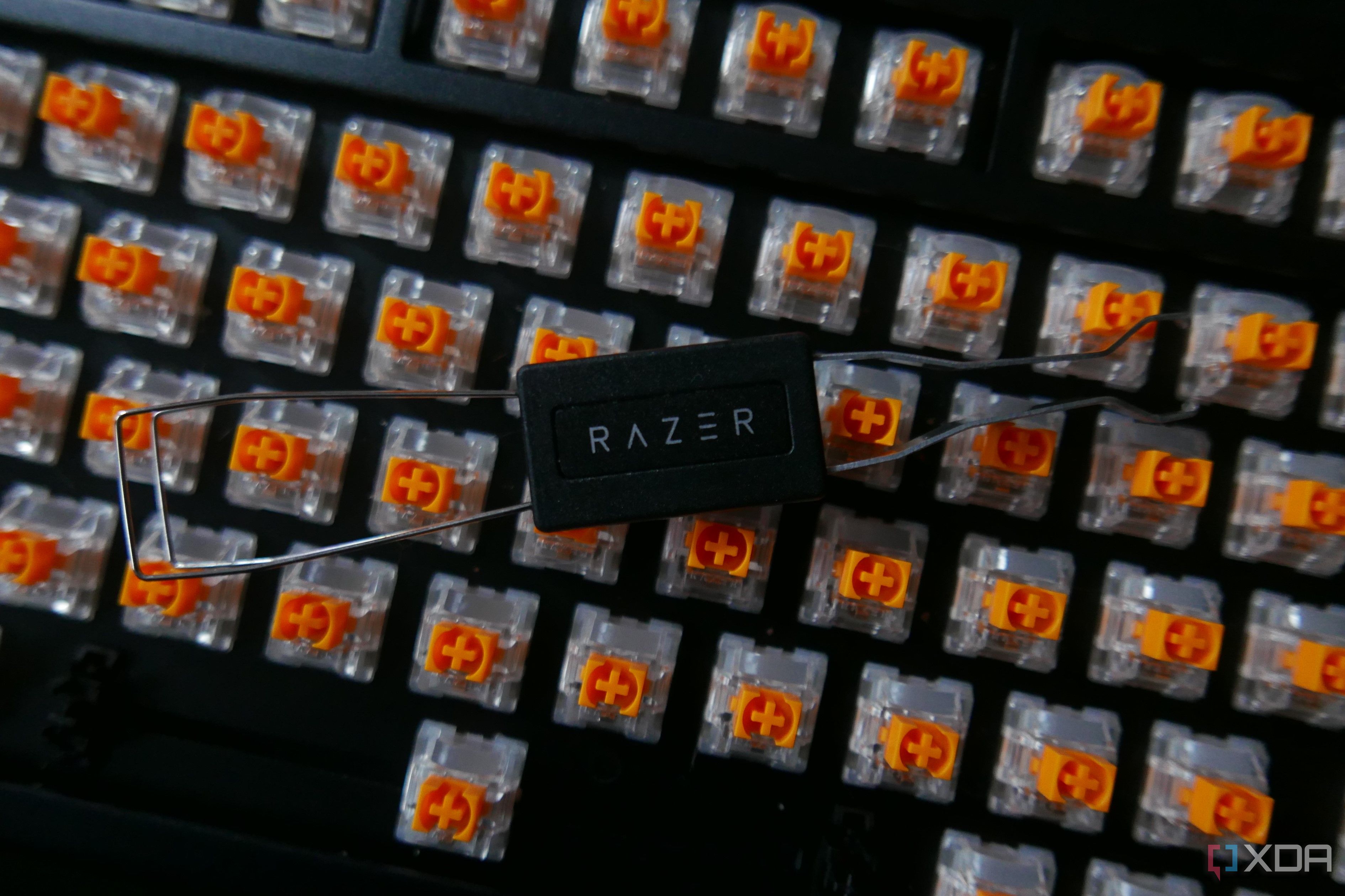 A Razer Blackwidow V4 75% with the keycaps removed and the switch puller on top