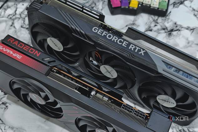 An image showing a GeForce RTX 4070 Ti and Radeon 7700XT GPUs kept on a table next to a split keyboard.