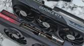 An image showing a GeForce RTX 4070 Ti and Radeon 7700XT GPUs kept on a table next to a split keyboard.