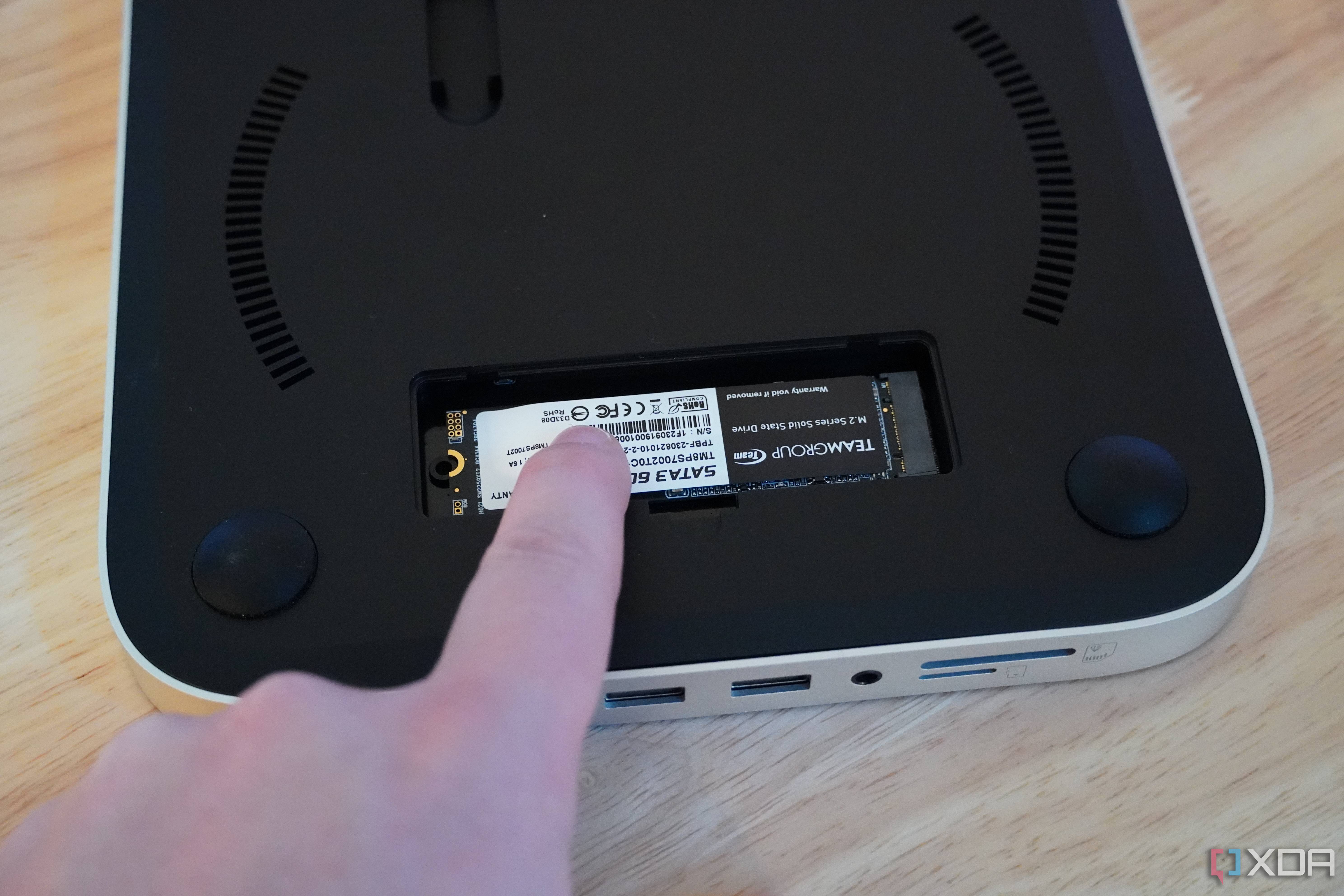 Holding down the SSD with a finger.