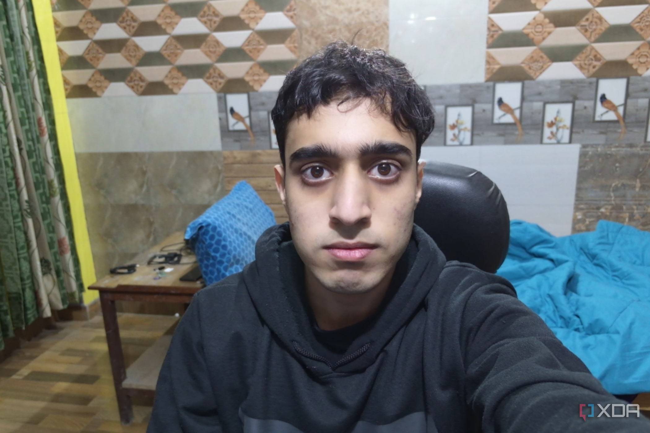 An image of a man sitting in front of the OBSBOT Tail Air webcam