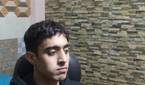 An image of a man sitting far away from the OBSBOT Tail Air webcam