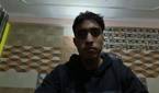 An image of a man sitting in front of the OBSBOT Tail Air webcam