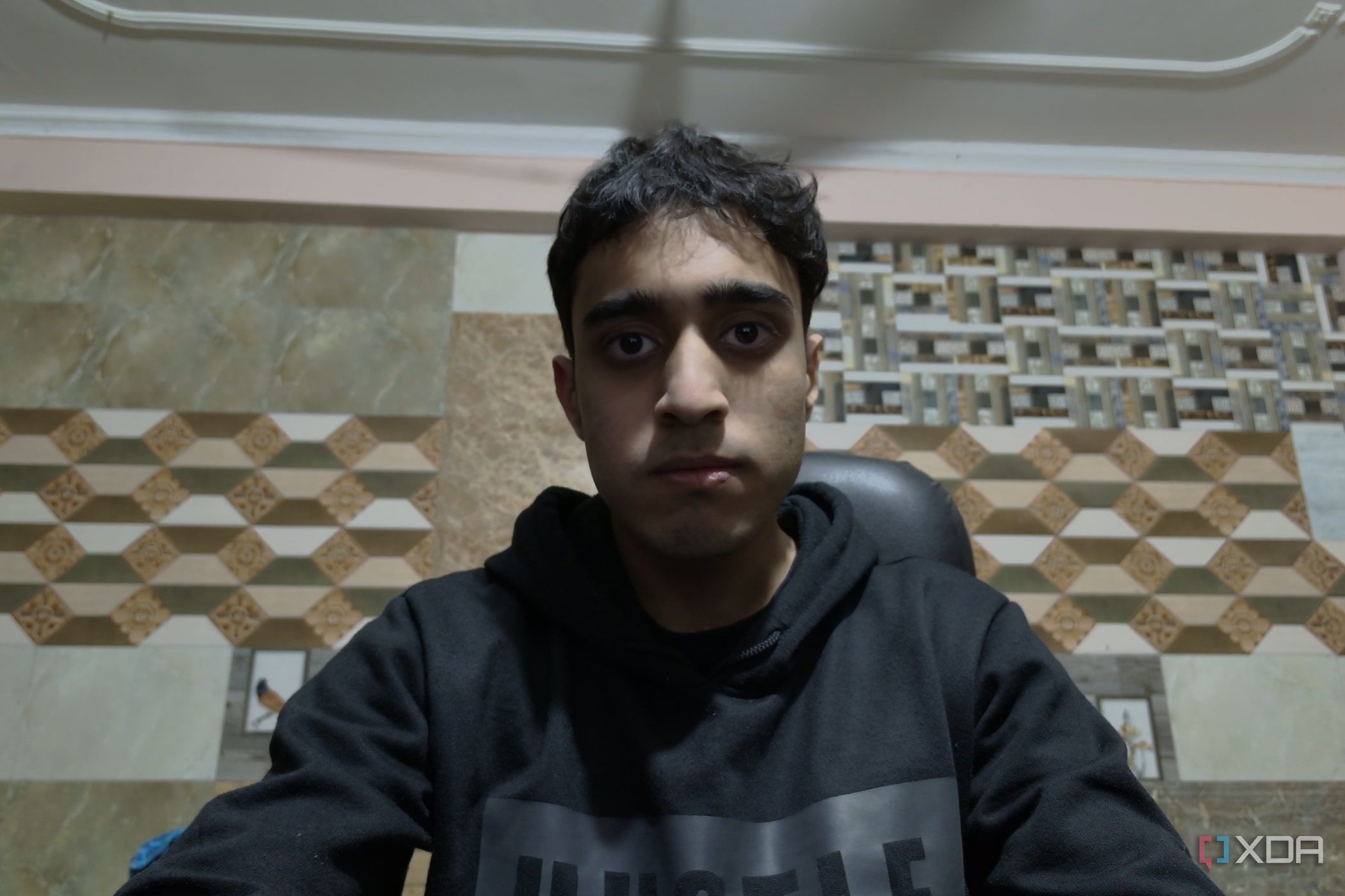 An image of a man sitting in front of the OBSBOT Tail Air webcam