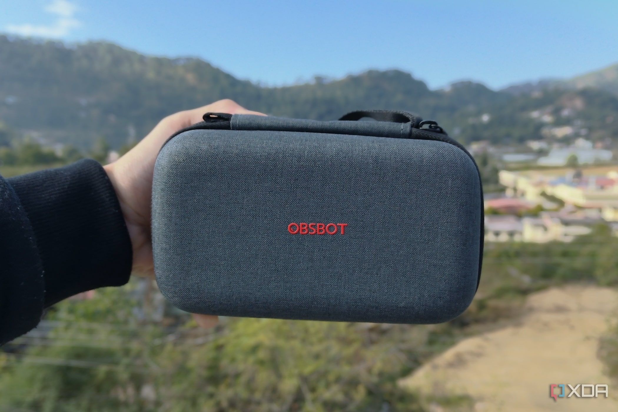 A person holding an OBSBOT Tail Air case