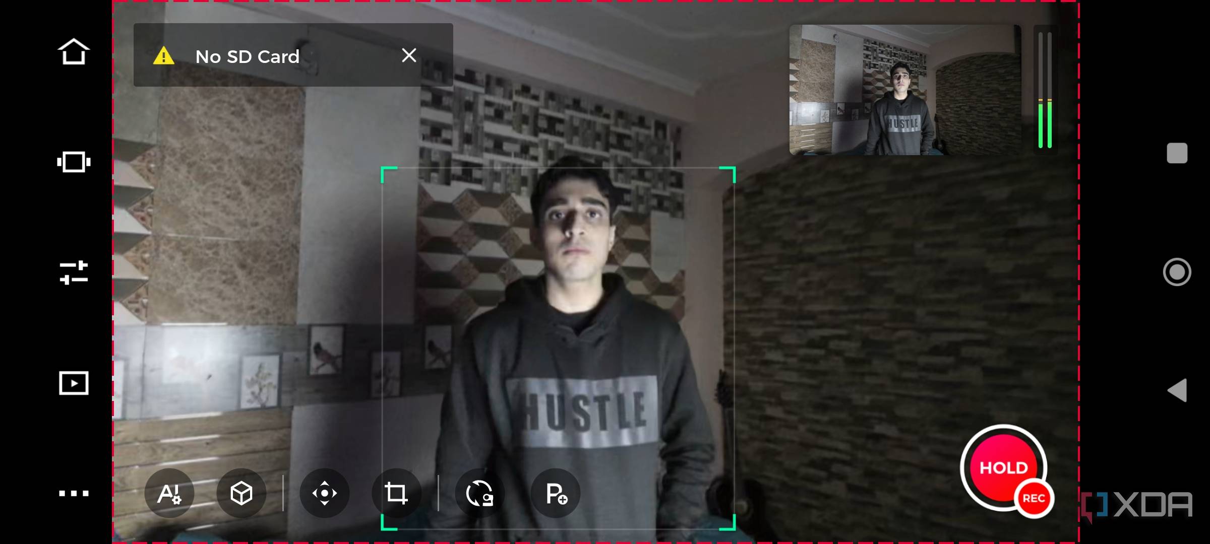 A mobile screenshot of a man standing in front of the OBSBOT Tail Air webcam