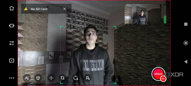 A mobile screenshot of a man standing in front of the OBSBOT Tail Air webcam
