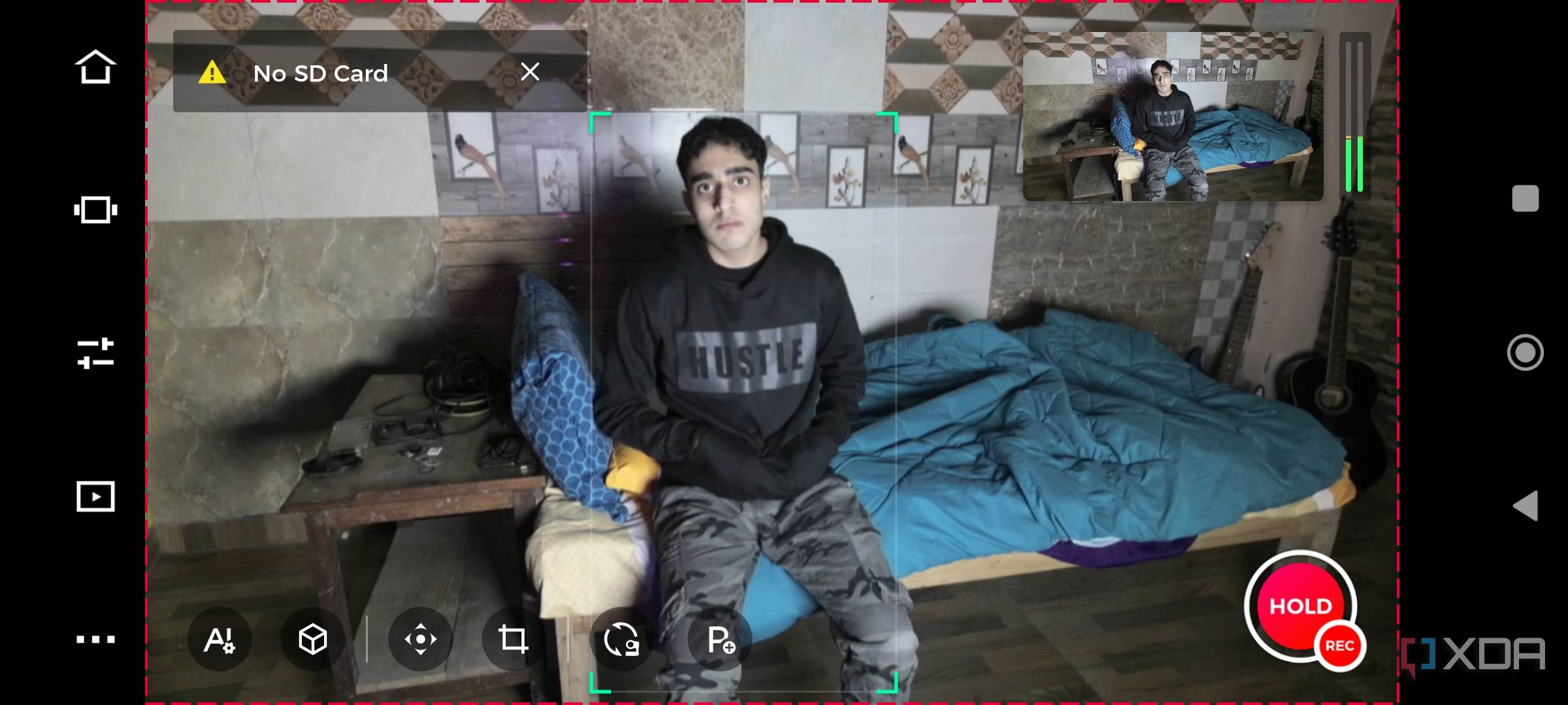 A mobile screenshot of a man sitting in front of the OBSBOT Tail Air webcam