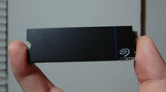 The Seagate Game Drive PS5 SSD held between two human fingers.