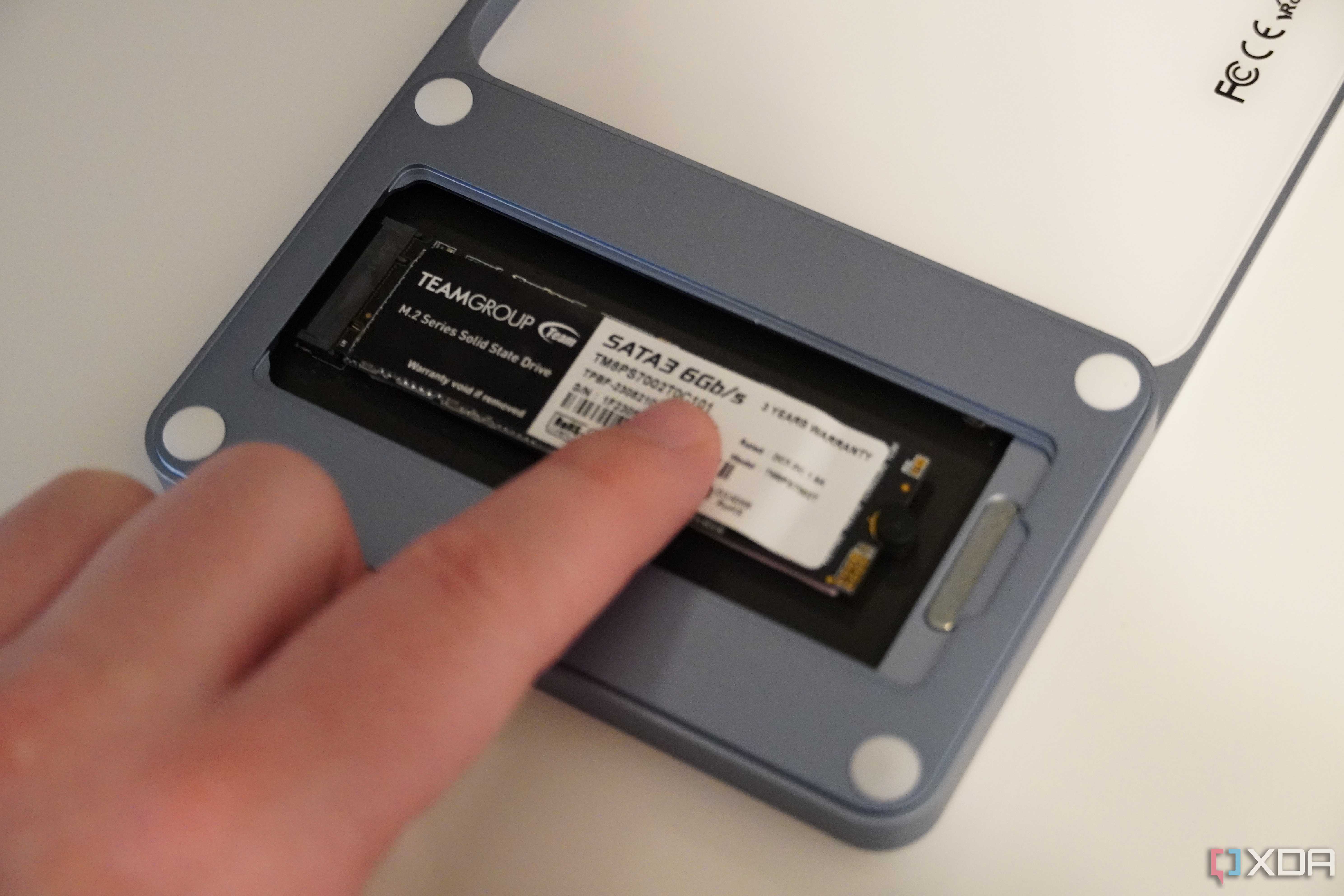 Inserting the SSD holder into the USB-C Slim Dock.