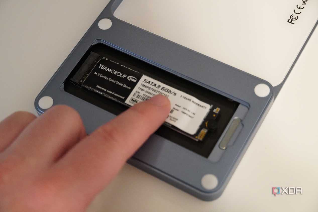 Inserting the SSD holder into the USB-C Slim Dock.