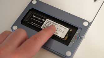 Inserting the SSD holder into the USB-C Slim Dock.