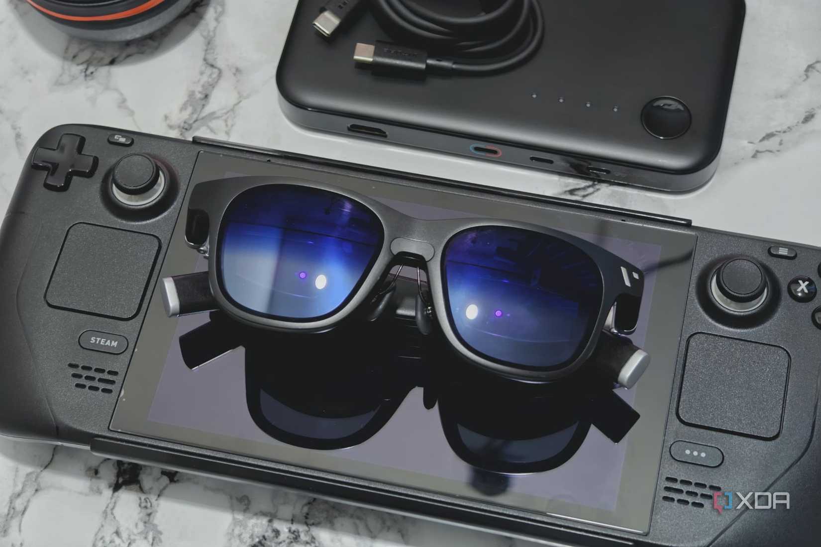 An image showing a pair of smart glasses placed on a Steam Deck.