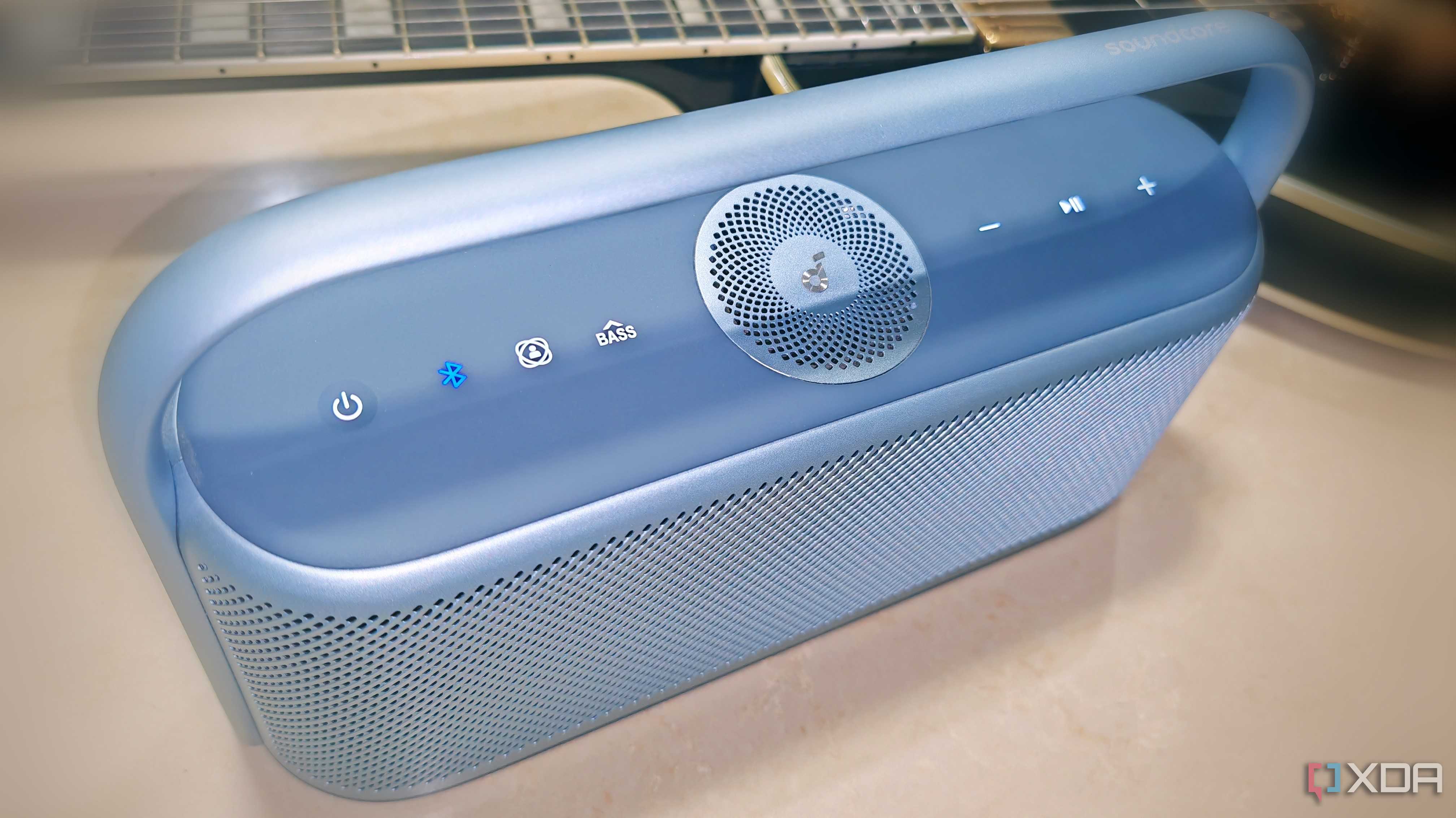 Soundcore Motion X600 in Lunar Blue with Black Les Paul guitar in background