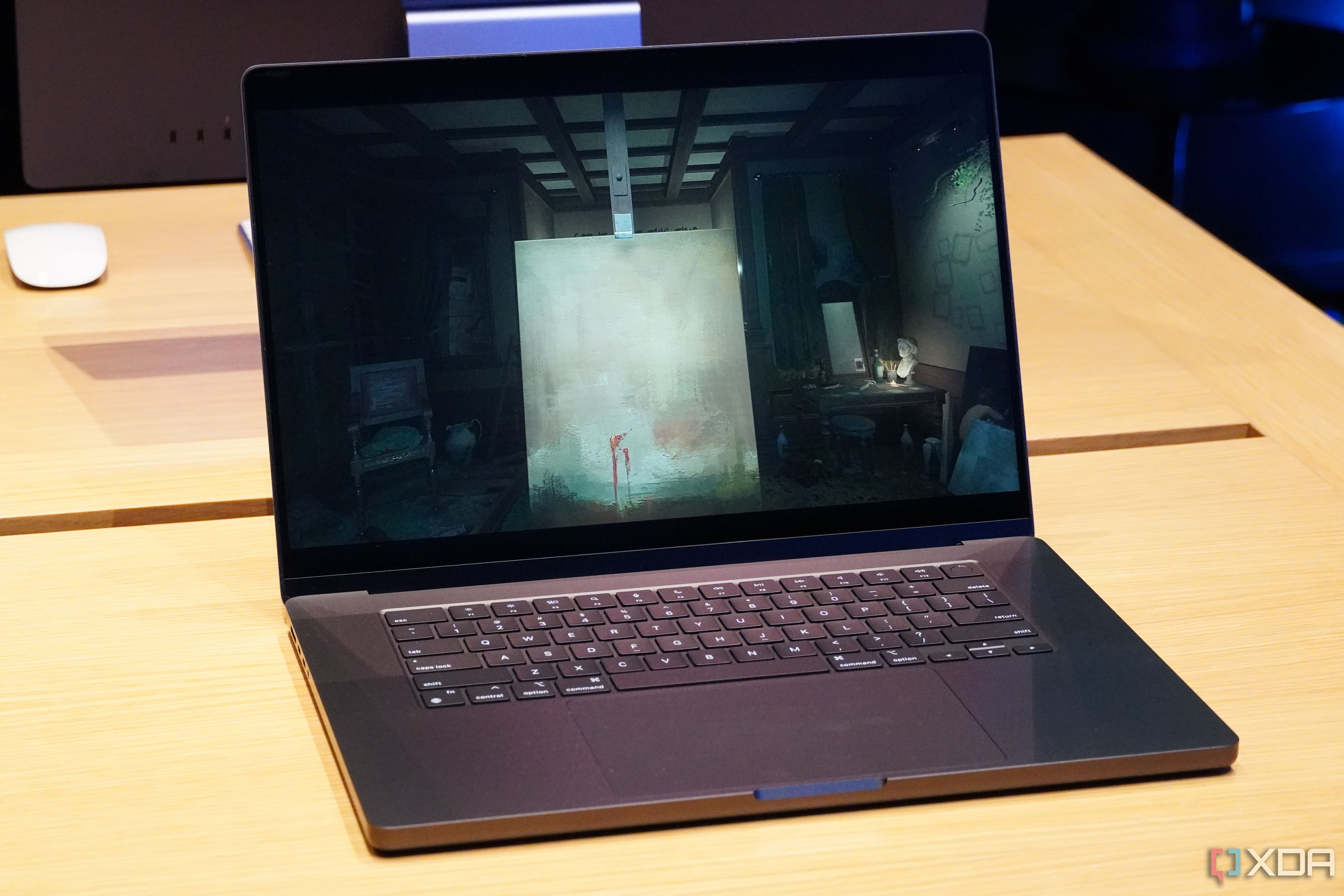 A Space Black MacBook Pro running a game.