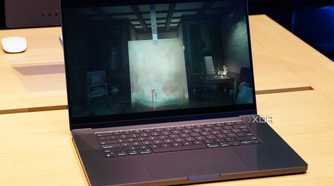 A Space Black MacBook Pro running a game.