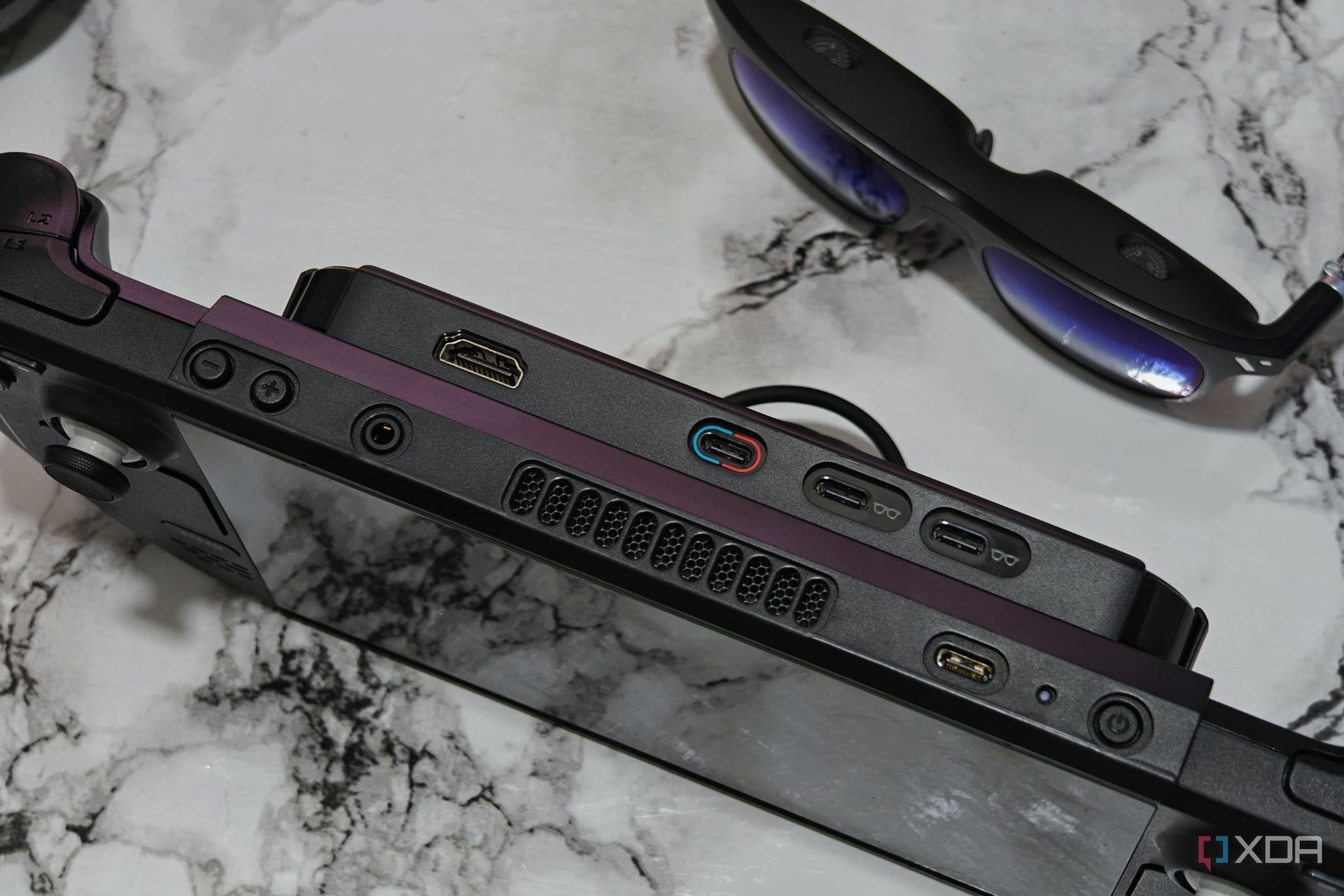 An image showing the Steam Deck placed next to Viture One smart glasses.