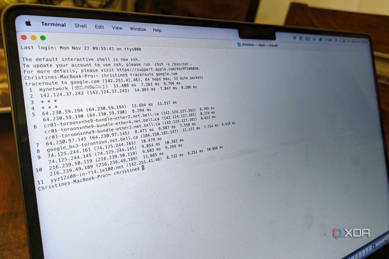 A sideview of a MacBook Pro showing the Terminal app running a traceroute.