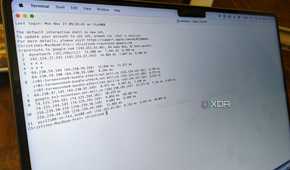 A sideview of a MacBook Pro showing the Terminal app running a traceroute.