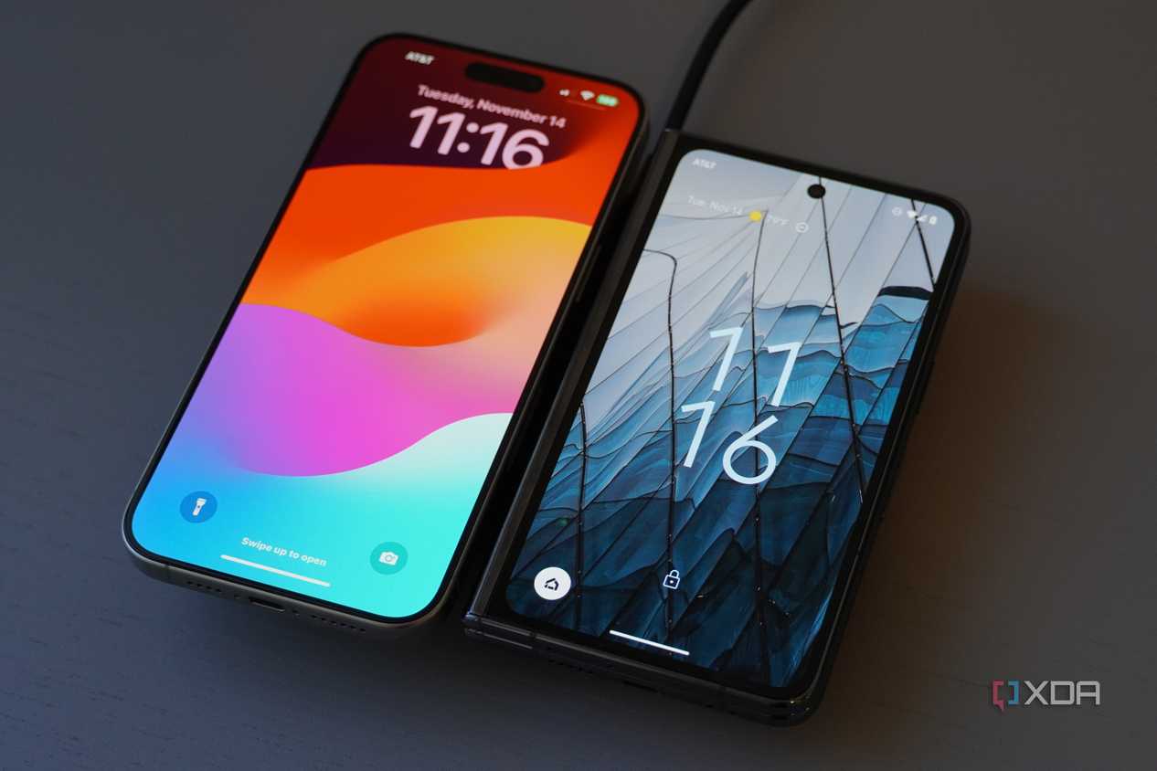Two phones charging on a Belkin wireless charging pad.