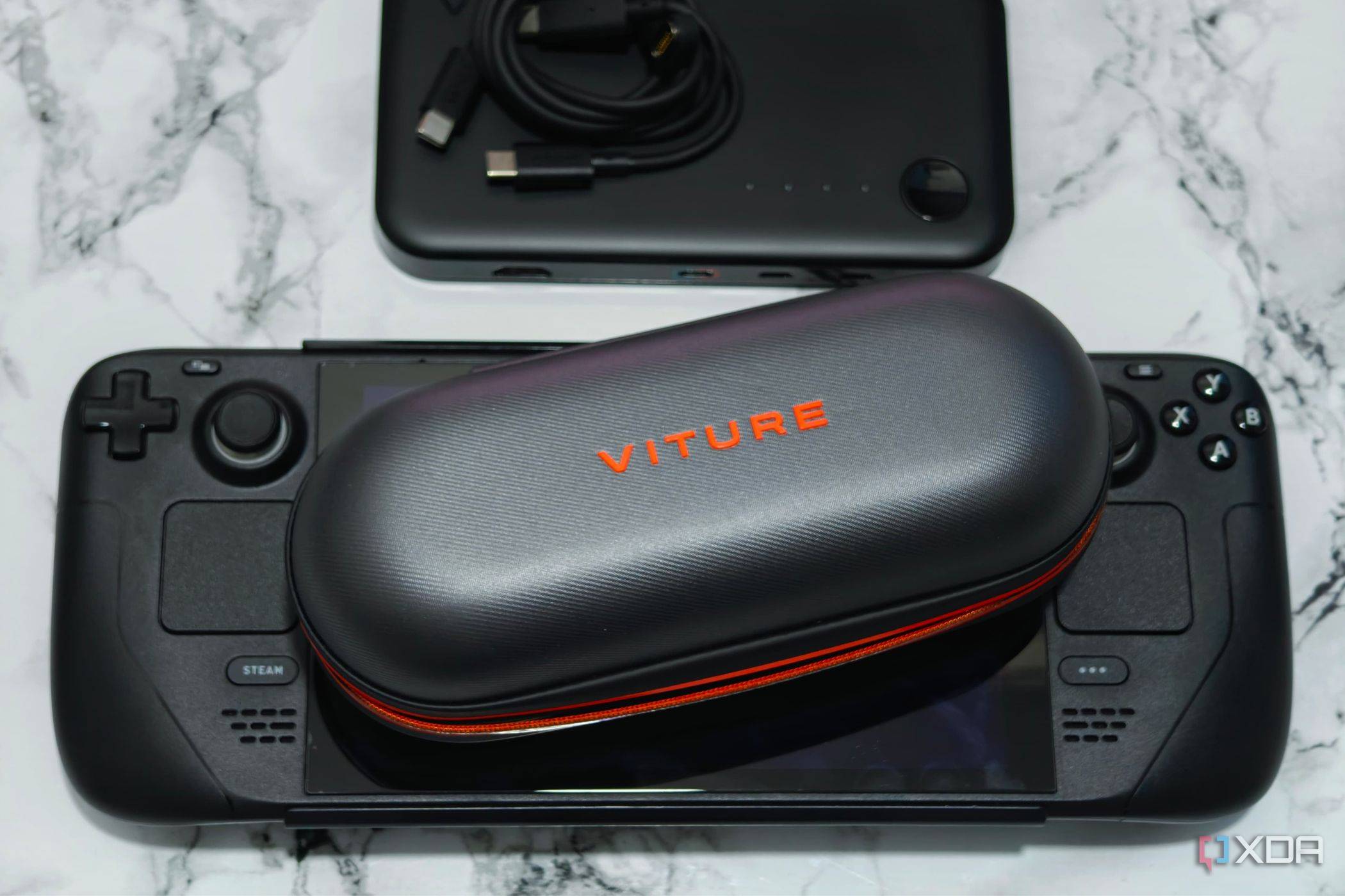 An image showing Viture smart glasses placed on a Steam Deck next to a dock.