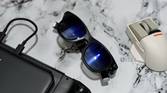 An image showing the Viture One glasses kept next to ta mouse and Steam Deck.