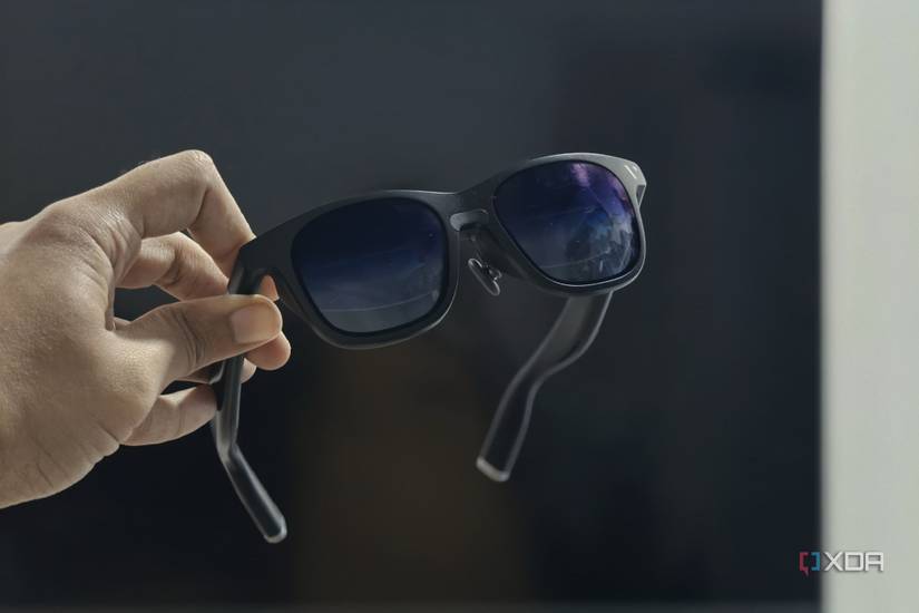An image showing a person holding the Viture XR in front of a tv.