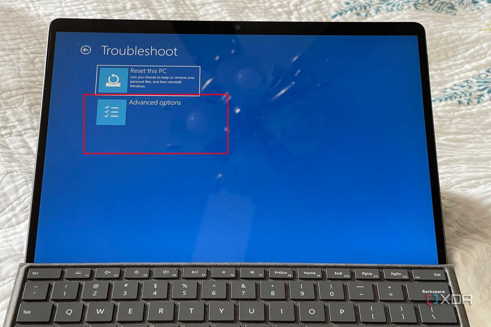 A photo of the Windows 11 troubleshoot screen showing where to click to get to advanced options 