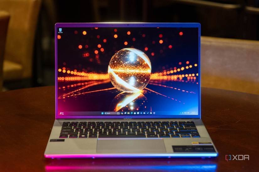 Acer Swift Go 14 on wooden table with pink and blue lighting