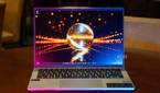 Acer Swift Go 14 on wooden table with pink and blue lighting
