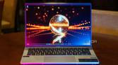 Acer Swift Go 14 on wooden table with pink and blue lighting