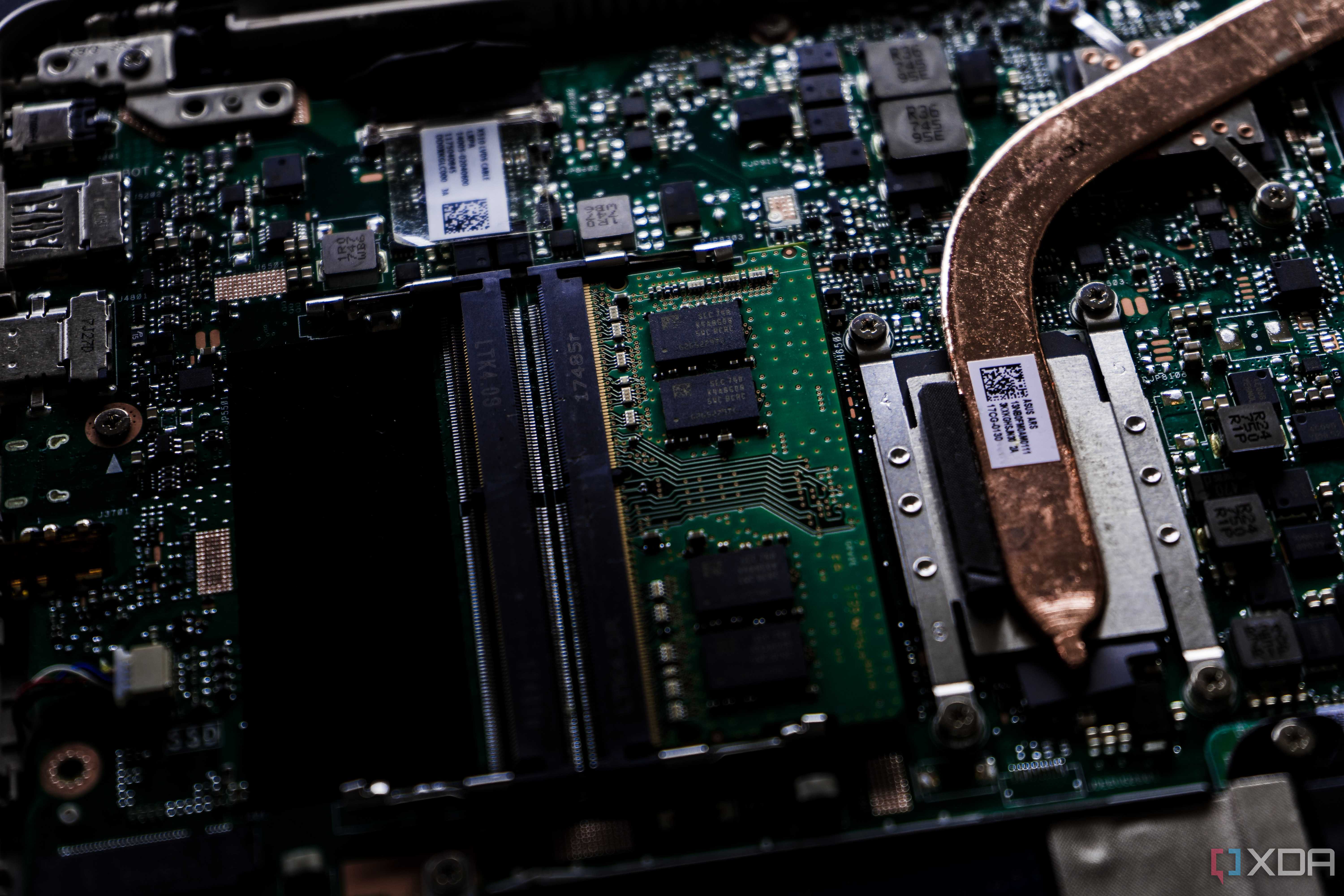 A close up image of a motherboard with a CPU heatsink extending offscreen, the rest of the motherboard is blurred in the background