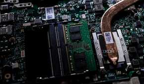 A close up image of a motherboard with a CPU heatsink extending offscreen, the rest of the motherboard is blurred in the background