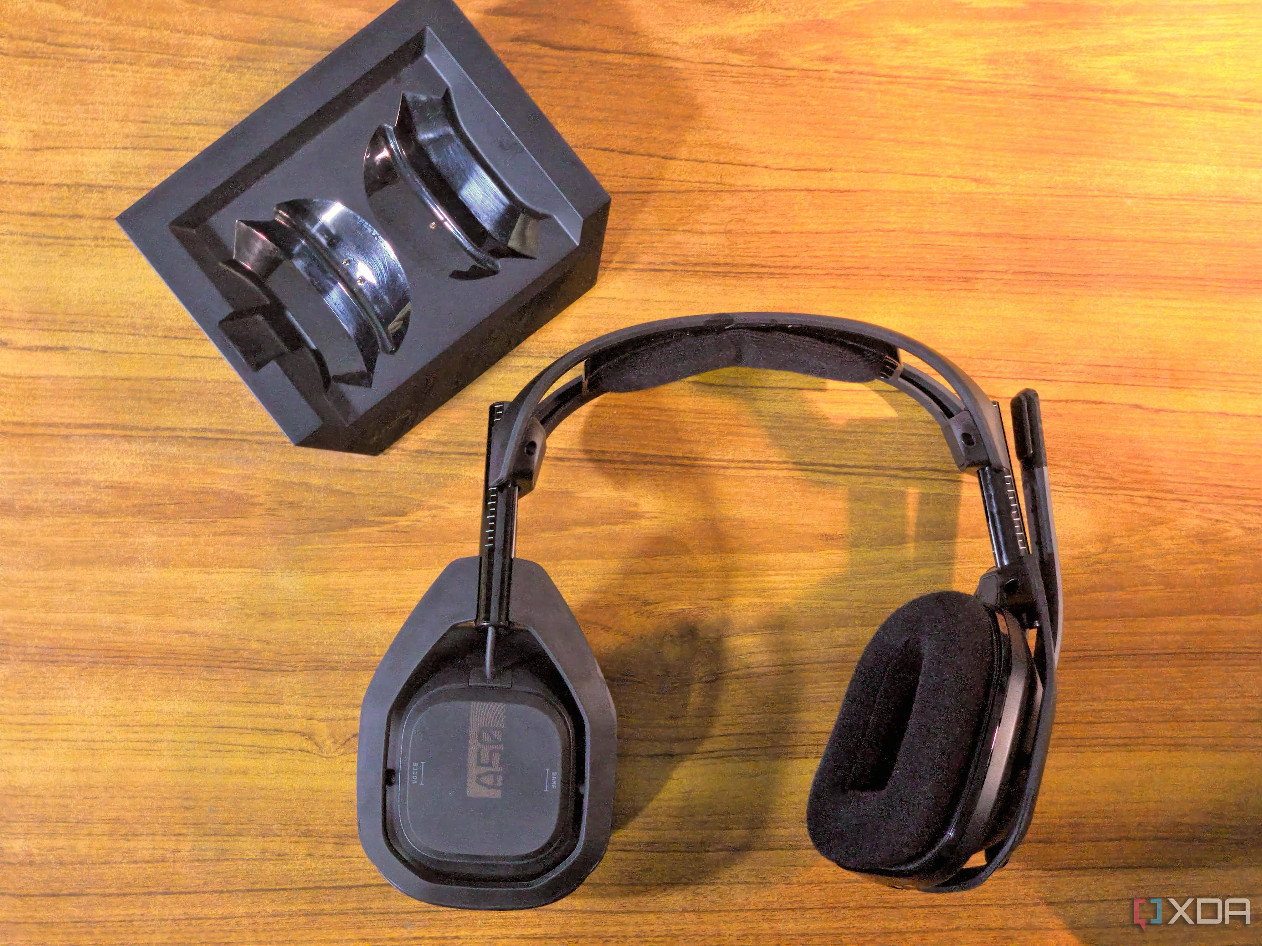 astro a50 (gen 4) on a table with its base station and one earpiece rotated