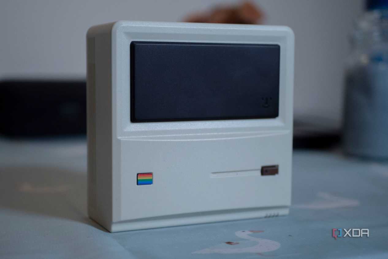 Ayaneo Retro Mini PC AM01 face up on a table, with a candle in the background
